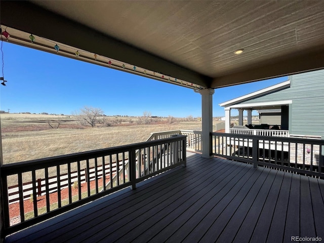 wooden terrace featuring a rural view