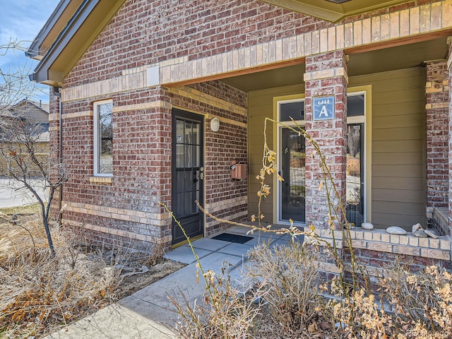 entrance to property with brick siding