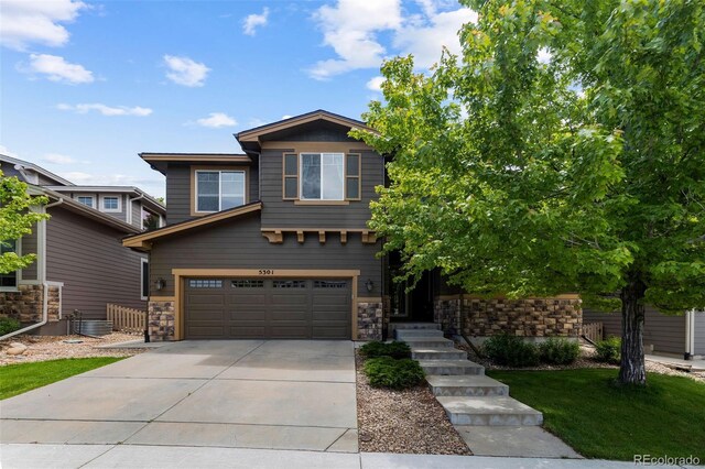 5301 Clovervale Cir, Highlands Ranch, CO 80130 - view of front of home featuring concrete driveway, a garage, and stone siding