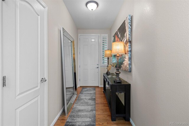 5301 Clovervale Cir, Highlands Ranch, CO 80130 - doorway featuring wood finished floors and baseboards