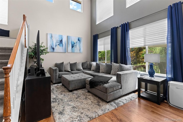 5301 Clovervale Cir, Highlands Ranch, CO 80130 - living room with stairs, wood finished floors, and a towering ceiling