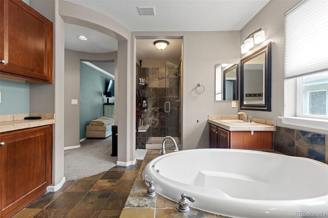 5301 Clovervale Cir, Highlands Ranch, CO 80130 - full bath with vanity, a stall shower, a bath, baseboards, and stone finish floors