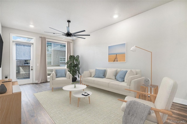 living room featuring hardwood / wood-style floors and ceiling fan