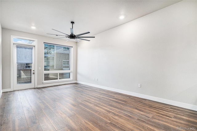 unfurnished room featuring ceiling fan and dark wood-type flooring