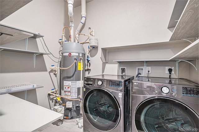 laundry area with washer and dryer and water heater