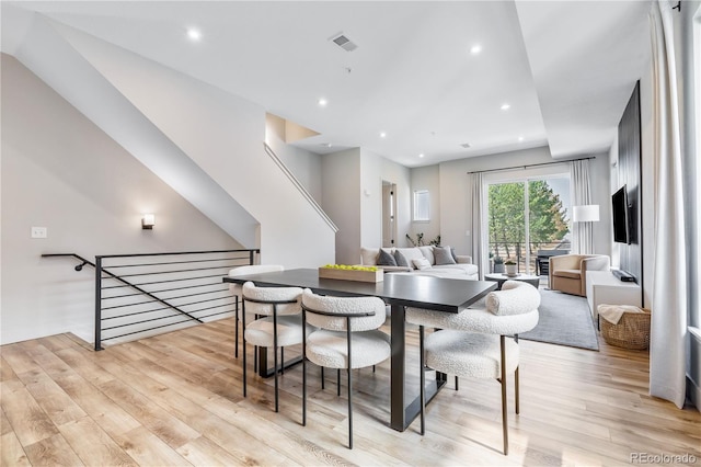 dining space with light hardwood / wood-style floors