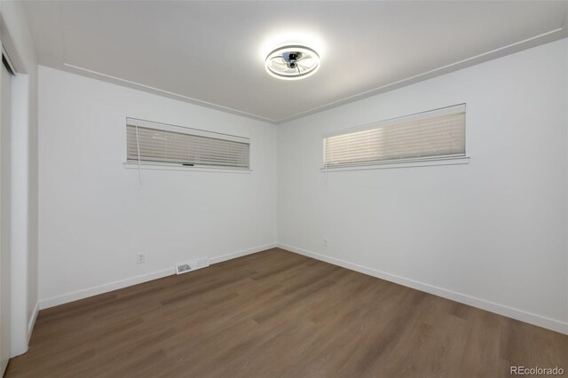 unfurnished room with hardwood / wood-style flooring