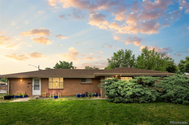 4785 Carr St, Wheat Ridge, CO 80033 - view of front of house with a yard and brick siding