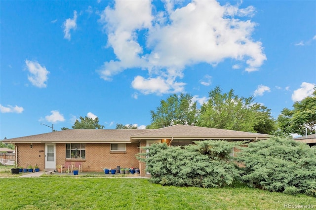 4785 Carr St, Wheat Ridge, CO 80033 - rear view of house with a yard and brick siding