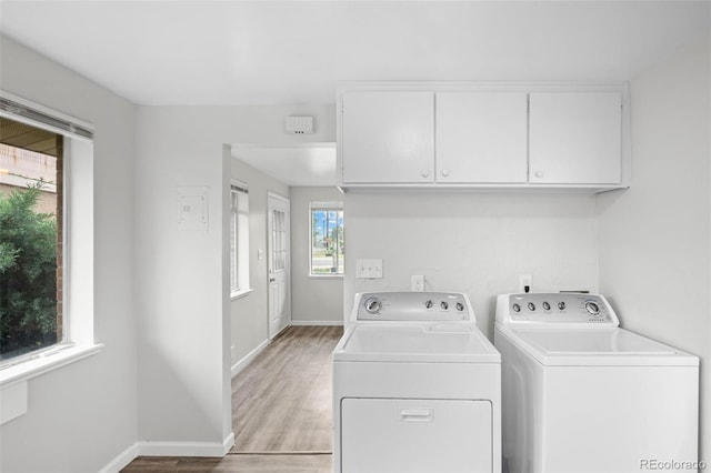 4785 Carr St, Wheat Ridge, CO 80033 - laundry area featuring cabinet space, washer and clothes dryer, and light wood finished floors