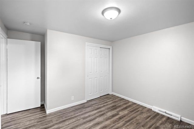 4785 Carr St, Wheat Ridge, CO 80033 - unfurnished bedroom with dark wood finished floors and a closet
