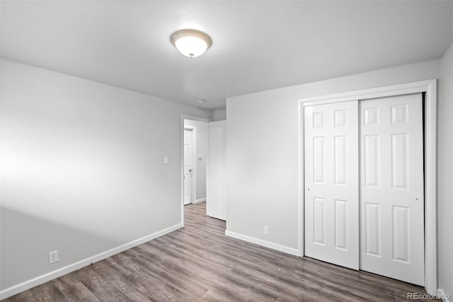 4785 Carr St, Wheat Ridge, CO 80033 - unfurnished bedroom with wood finished floors and a closet