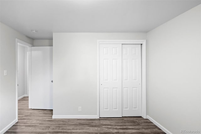 4785 Carr St, Wheat Ridge, CO 80033 - unfurnished bedroom featuring dark wood finished floors and a closet