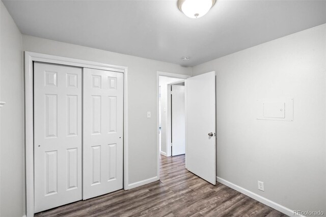 4785 Carr St, Wheat Ridge, CO 80033 - unfurnished bedroom with dark wood finished floors and a closet