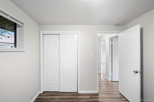 4785 Carr St, Wheat Ridge, CO 80033 - unfurnished bedroom with dark wood-type flooring and a closet