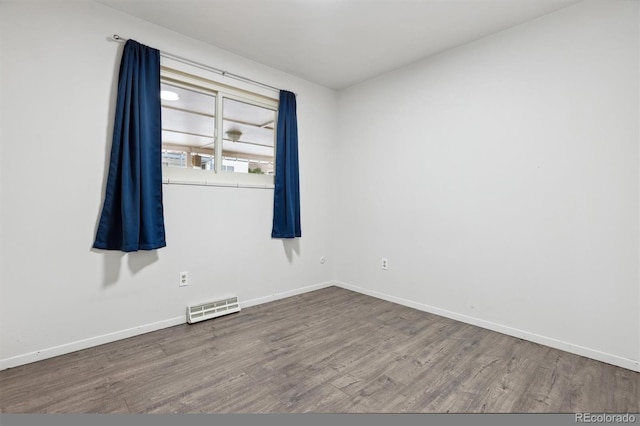 spare room with hardwood / wood-style floors