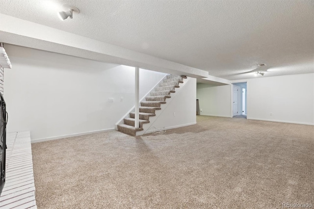 basement featuring carpet and a textured ceiling