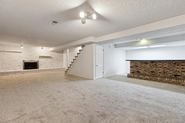 basement with carpet flooring, brick wall, and a textured ceiling