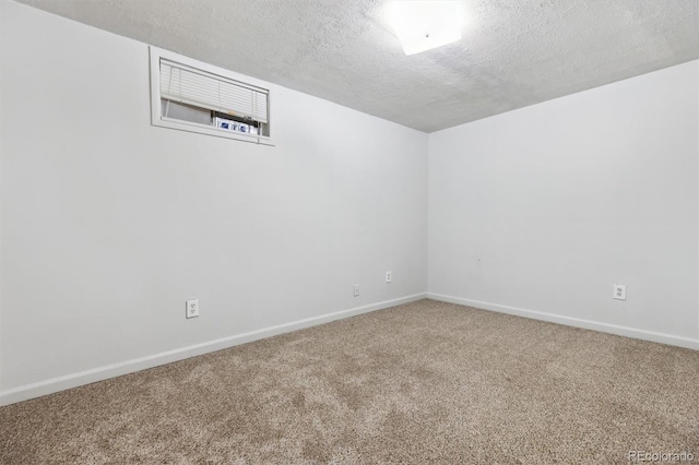 carpeted spare room with a textured ceiling