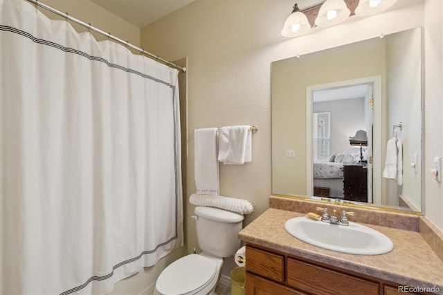 full bathroom with a shower with curtain, vanity, toilet, and connected bathroom