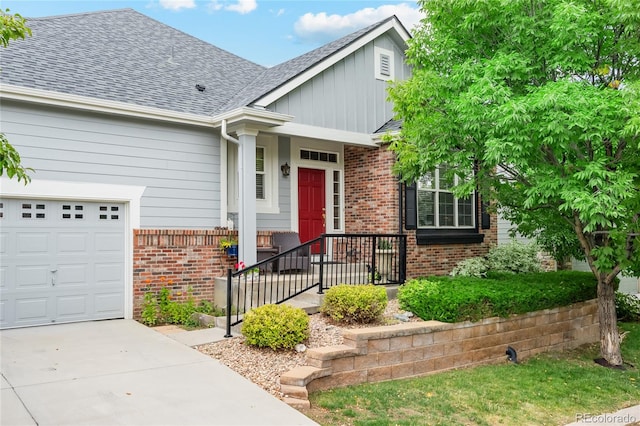 view of front of home with a garage, concrete driveway, brick siding, and roof with shingles