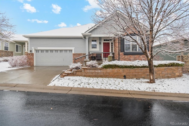 ranch-style home featuring concrete driveway, brick siding, and an attached garage