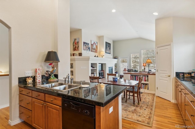 kitchen with tile countertops, a sink, vaulted ceiling, dishwasher, and light wood finished floors