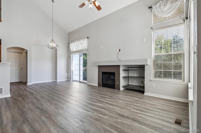 unfurnished living room featuring hardwood / wood-style flooring, high vaulted ceiling, and a wealth of natural light