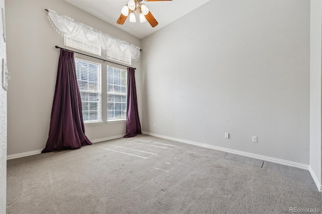 carpeted empty room featuring vaulted ceiling and ceiling fan