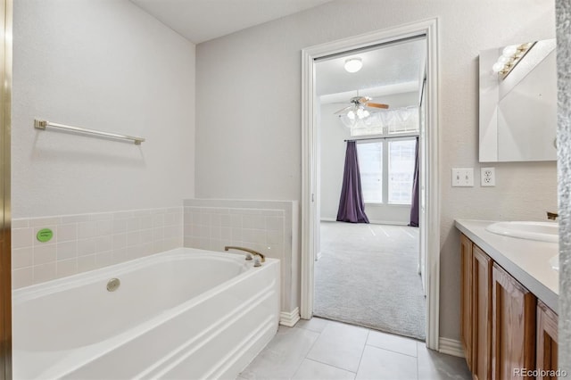 bathroom featuring vanity, a washtub, ceiling fan, and tile patterned floors