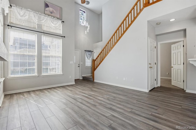 entryway with a towering ceiling and hardwood / wood-style floors