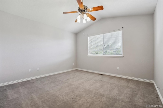 empty room with ceiling fan, lofted ceiling, and light carpet