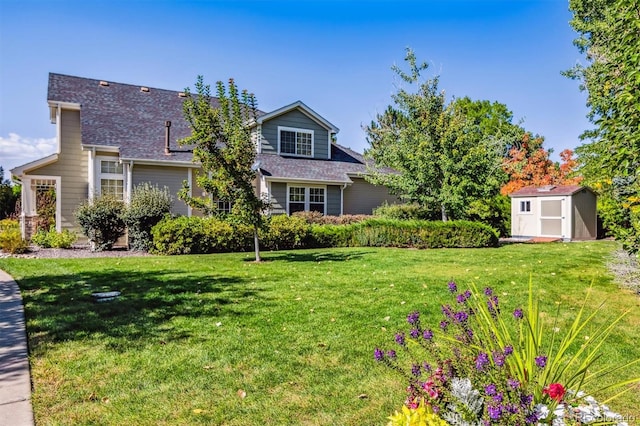 view of front of home with a storage shed and a front yard