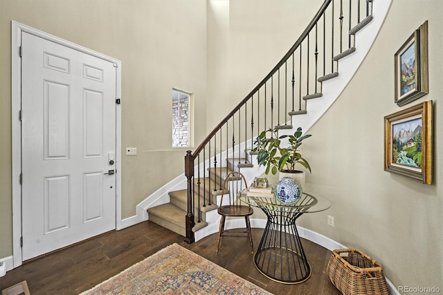 15033 Delhi Ave, Parker, CO 80134 - foyer entrance featuring dark wood-style flooring, stairway, baseboards, and a towering ceiling