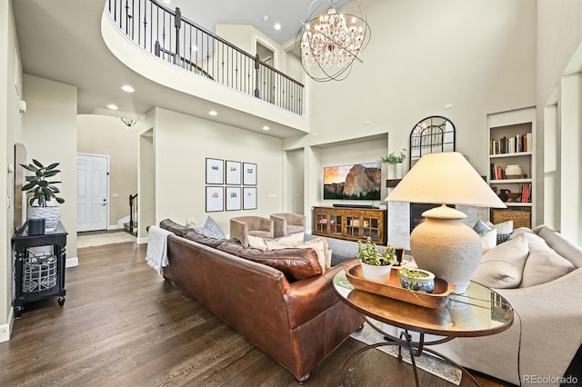 15033 Delhi Ave, Parker, CO 80134 - living room featuring a towering ceiling, wood finished floors, baseboards, built in shelves, and recessed lighting