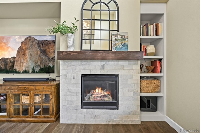 15033 Delhi Ave, Parker, CO 80134 - detailed view of wood finished floors, baseboards, a glass covered fireplace, and built in features