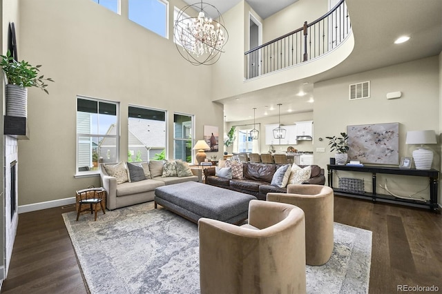 15033 Delhi Ave, Parker, CO 80134 - living area featuring a towering ceiling, dark wood-type flooring, baseboards, and a chandelier