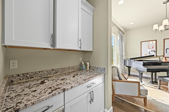 15033 Delhi Ave, Parker, CO 80134 - bar featuring wood finished floors, decorative light fixtures, baseboards, and recessed lighting