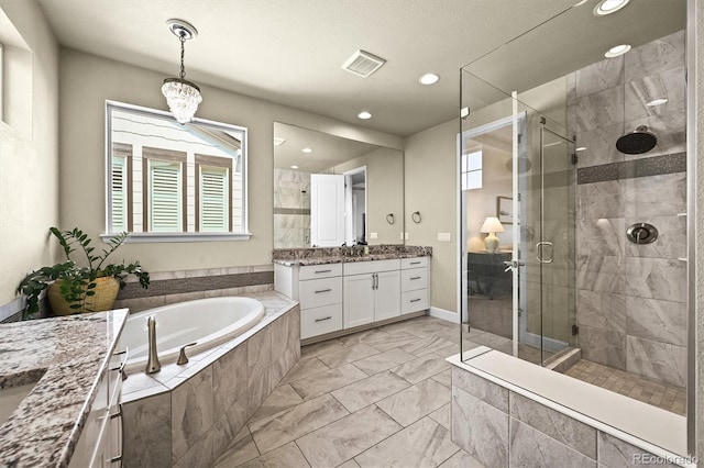 15033 Delhi Ave, Parker, CO 80134 - bathroom featuring vanity, a shower stall, a garden tub, marble finish flooring, and recessed lighting