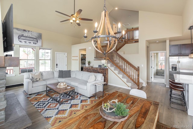 327 Summit Lift Ct, Granby, CO 80446 - living area featuring stairs, high vaulted ceiling, a chandelier, ceiling fan, and wood finished floors