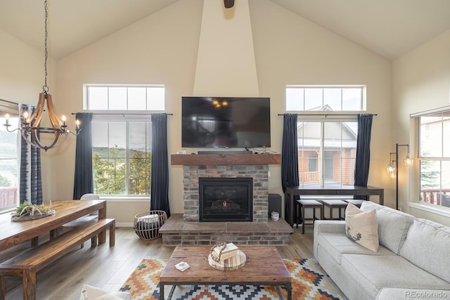 327 Summit Lift Ct, Granby, CO 80446 - living room with high vaulted ceiling, a chandelier, wood finished floors, a fireplace, and baseboards