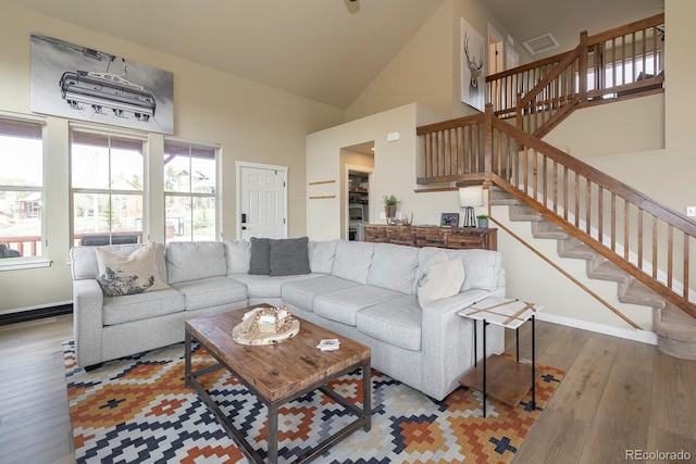 327 Summit Lift Ct, Granby, CO 80446 - living room featuring wood finished floors, stairway, high vaulted ceiling, and baseboards