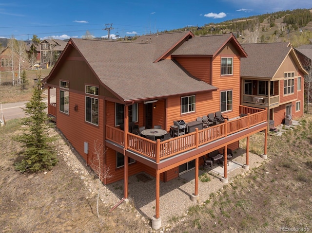327 Summit Lift Ct, Granby, CO 80446 - rear view of house featuring roof with shingles, a wooden deck, and outdoor lounge area