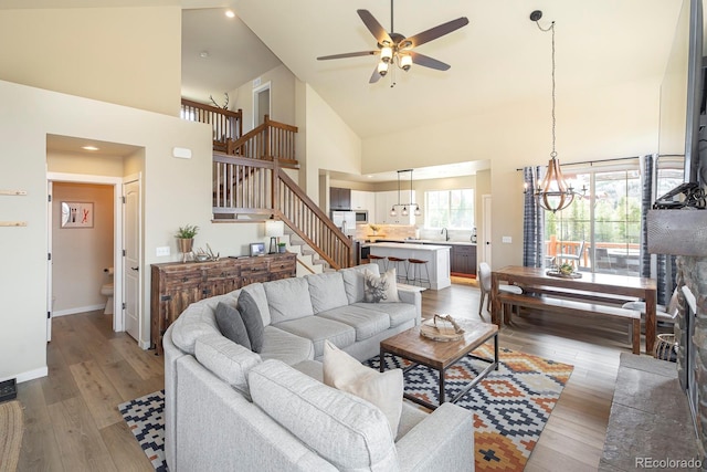 327 Summit Lift Ct, Granby, CO 80446 - living area featuring stairway, high vaulted ceiling, ceiling fan, wood finished floors, and baseboards