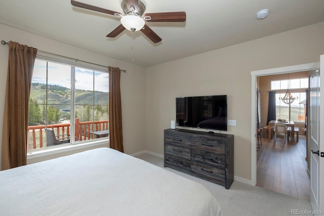327 Summit Lift Ct, Granby, CO 80446 - carpeted bedroom with multiple windows, baseboards, and a chandelier