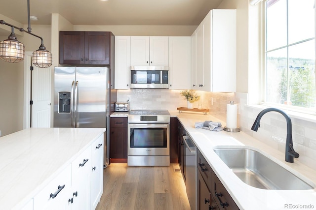 327 Summit Lift Ct, Granby, CO 80446 - kitchen featuring stainless steel appliances, a sink, light countertops, and light wood-style flooring