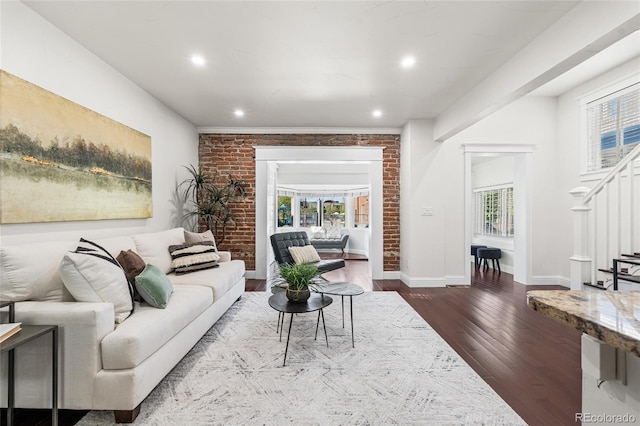 living room featuring dark wood-style floors, stairs, healthy amount of natural light, recessed lighting, and baseboards