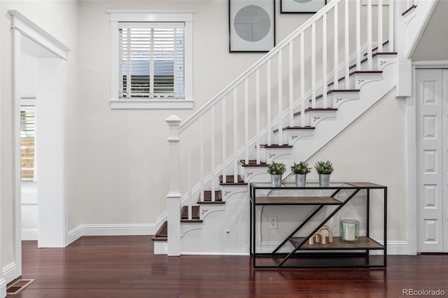 staircase featuring hardwood / wood-style floors, plenty of natural light, and baseboards