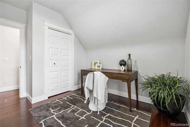 office area featuring lofted ceiling, hardwood / wood-style floors, and baseboards