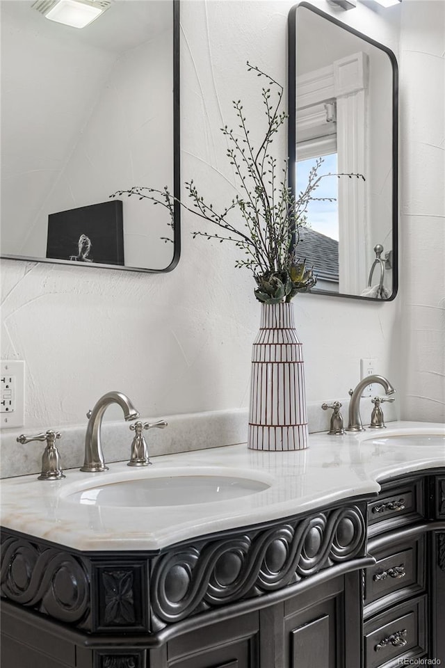 bathroom with vanity and vaulted ceiling